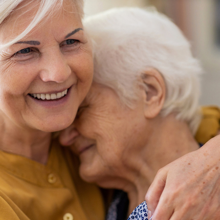 Foto: Zwei ältere Frauen liegen sich in den Armen