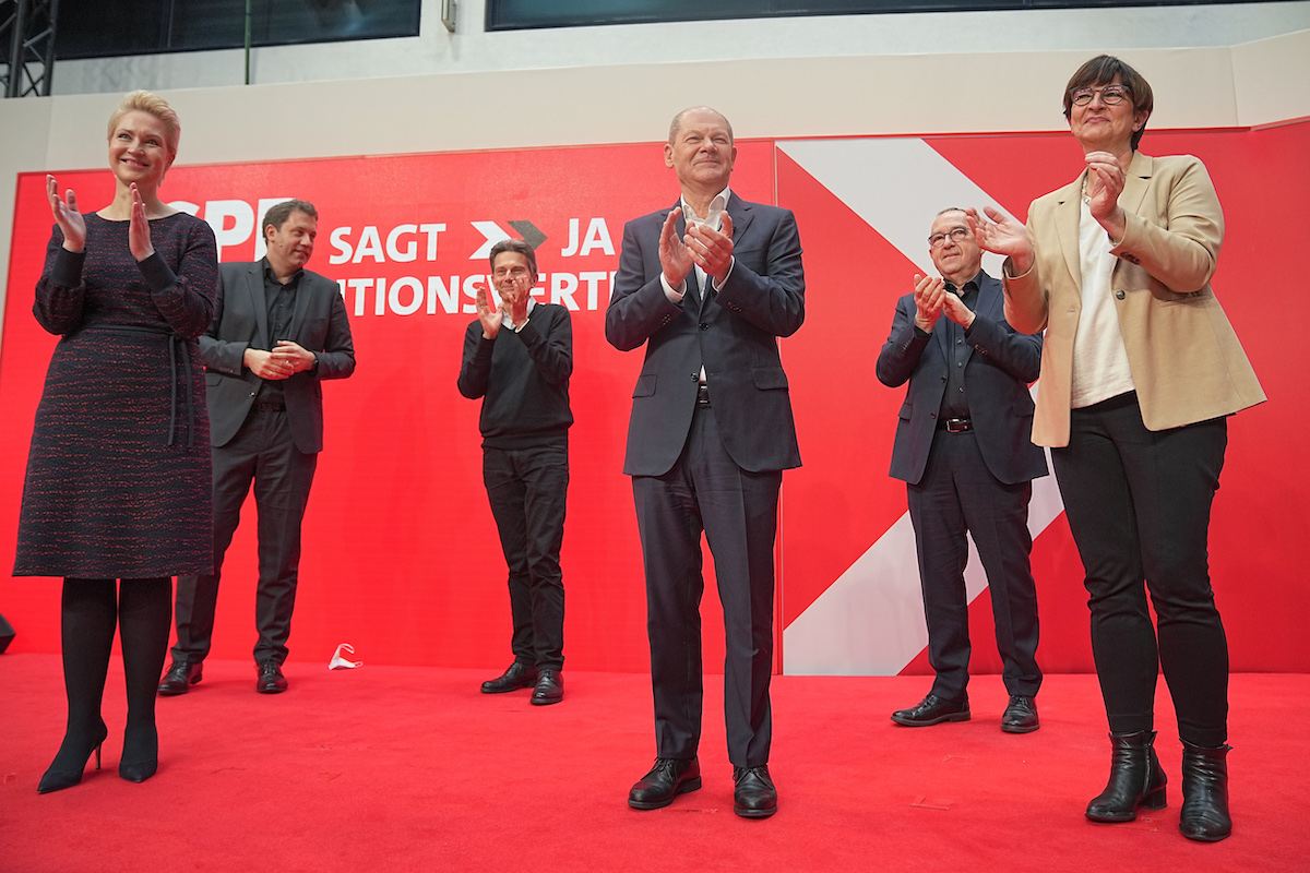 Foto: Olaf Scholz (M) applaudiert zusammen mit Manuela Schwesig (l-r), Lars Klingbeil, Rolf Mützenich, Norbert Walter-Borjans und Saskia Esken nach der Zustimmung beim SPD-Parteitag 